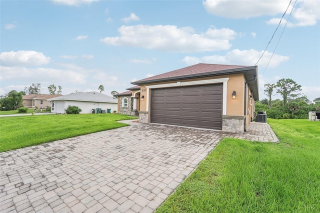 view of front facade with cooling unit, a front yard, and a garage