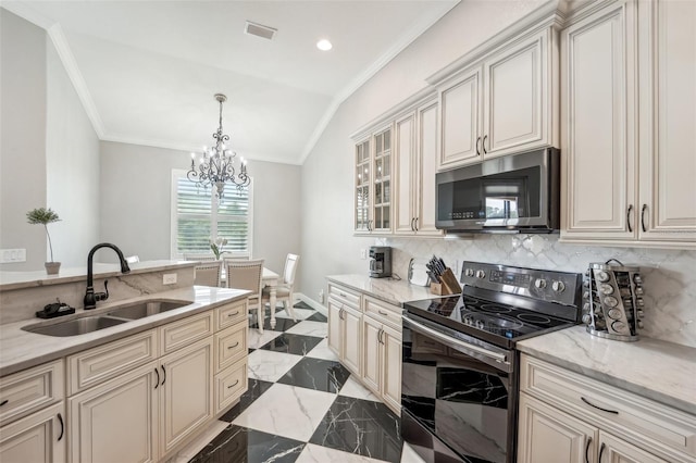 kitchen with cream cabinets, sink, light stone countertops, and black range with electric cooktop