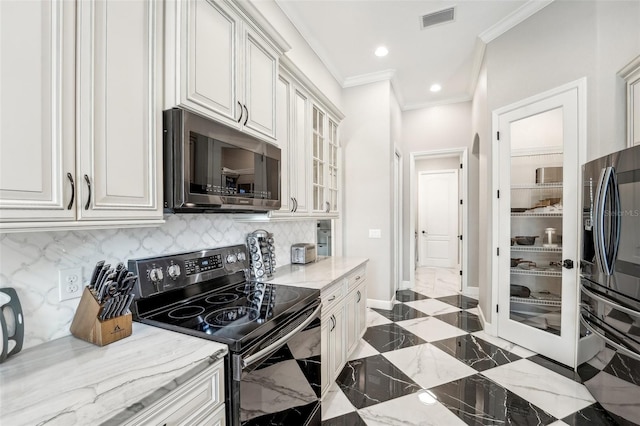 kitchen featuring decorative backsplash, white cabinetry, and appliances with stainless steel finishes