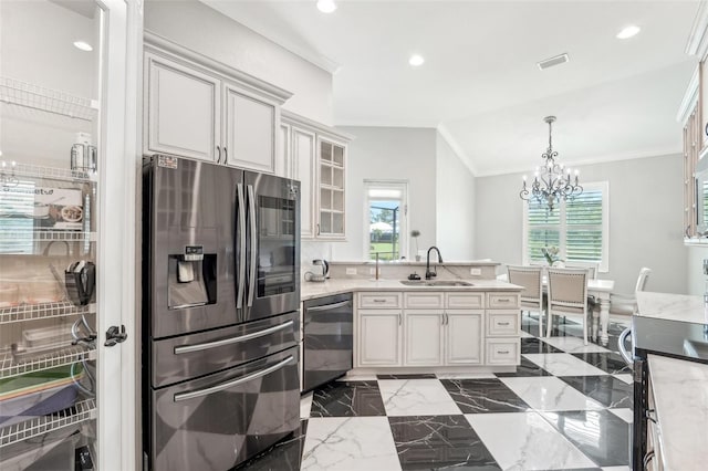 kitchen with sink, crown molding, a chandelier, vaulted ceiling, and appliances with stainless steel finishes