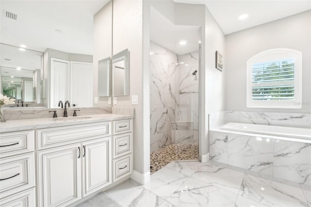 bathroom featuring vanity and shower with separate bathtub