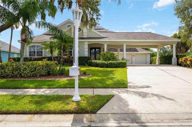 view of front of property with a front lawn, a garage, and a carport