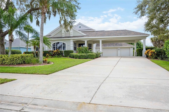 view of front of home with a front yard and a garage