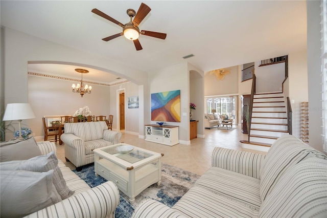 living room featuring light tile patterned floors, crown molding, and ceiling fan with notable chandelier