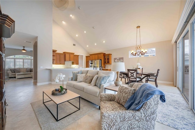 living room featuring ceiling fan with notable chandelier and high vaulted ceiling