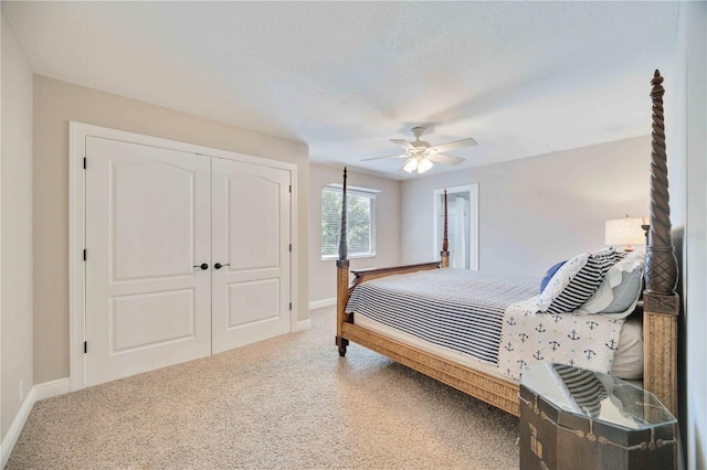 carpeted bedroom with ceiling fan and a closet