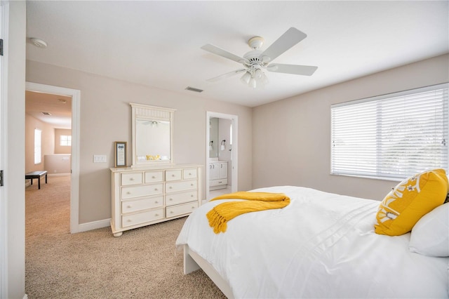 carpeted bedroom featuring ensuite bathroom and ceiling fan