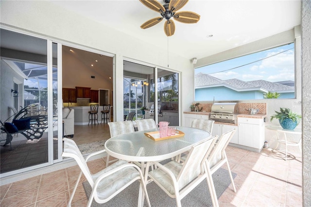 sunroom with ceiling fan and vaulted ceiling