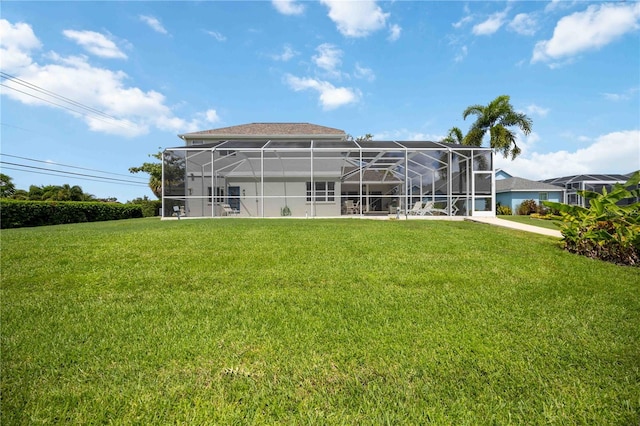 back of property featuring a lawn and a lanai