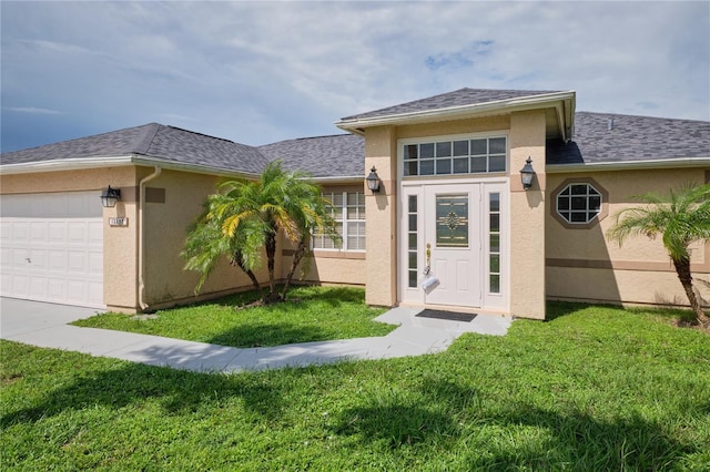 property entrance with a lawn and a garage