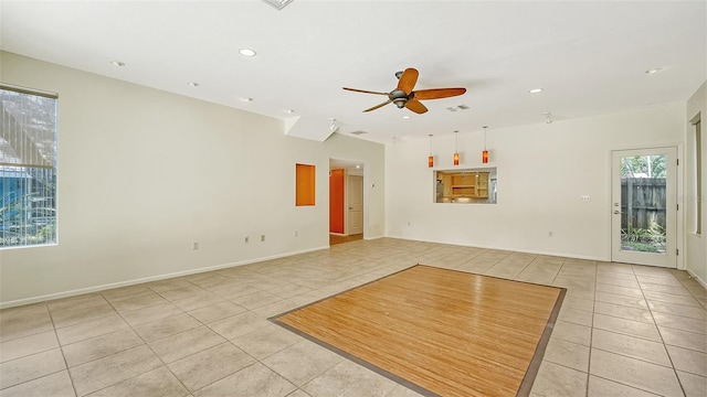 empty room with ceiling fan and light tile patterned floors