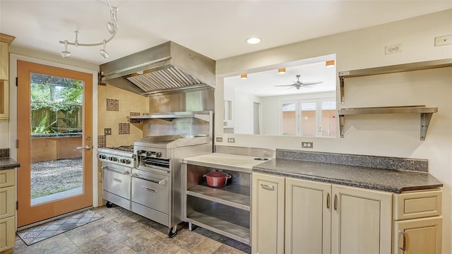 kitchen with vaulted ceiling, cream cabinets, ceiling fan, french doors, and custom range hood