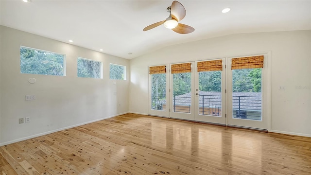 spare room with french doors, ceiling fan, light wood-type flooring, and vaulted ceiling