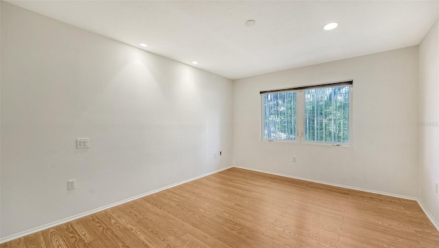 empty room with light hardwood / wood-style flooring