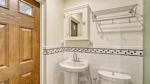 bathroom featuring tile walls and tasteful backsplash