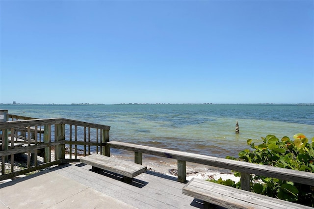 exterior space featuring a beach view and a water view