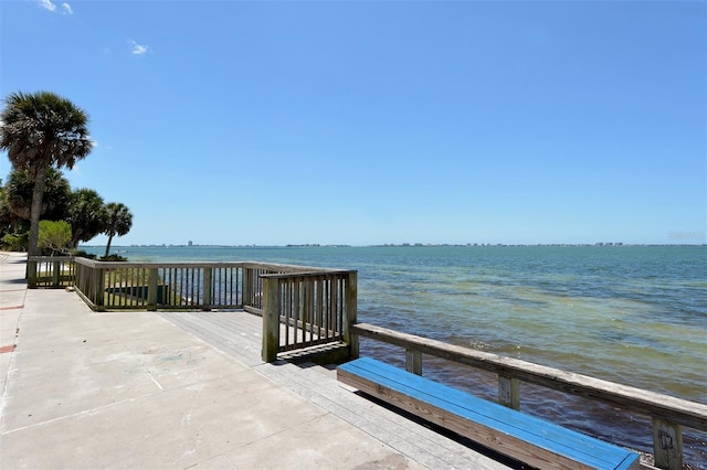 view of dock with a deck with water view