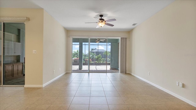 tiled empty room with ceiling fan