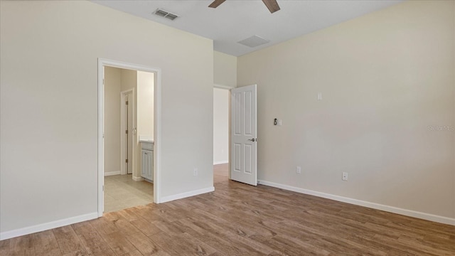 unfurnished bedroom with ceiling fan, connected bathroom, and light hardwood / wood-style floors