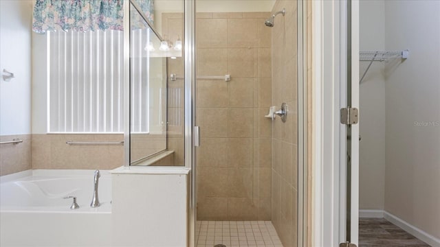 bathroom with wood-type flooring and plus walk in shower