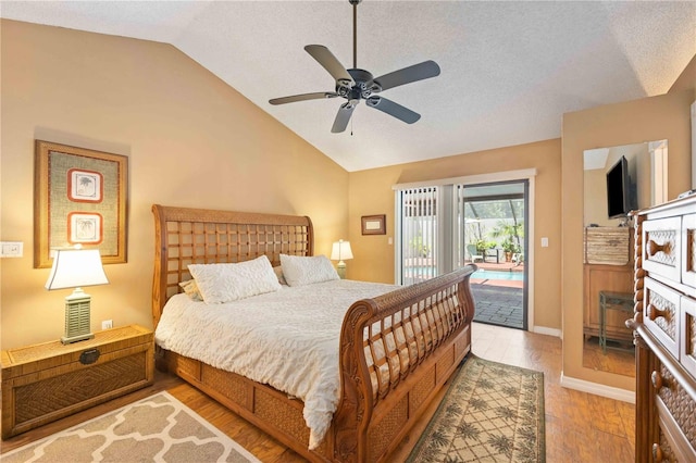 bedroom with a textured ceiling, light hardwood / wood-style flooring, access to exterior, ceiling fan, and lofted ceiling