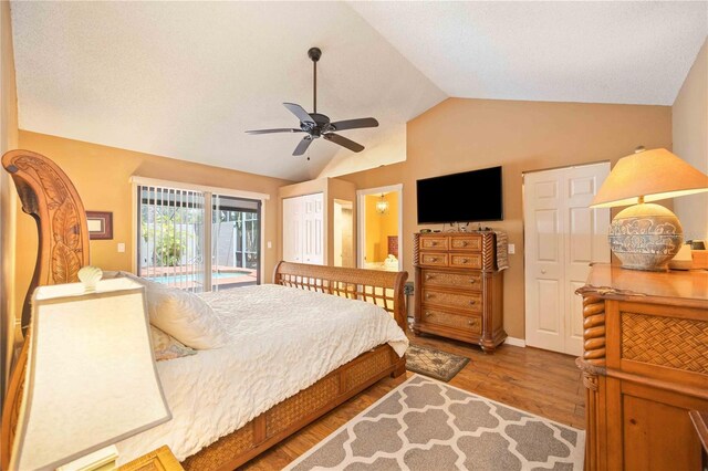 bedroom featuring lofted ceiling, ceiling fan, dark hardwood / wood-style floors, and access to outside