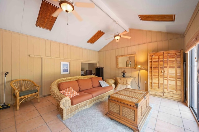 tiled living room with ceiling fan, wooden walls, and lofted ceiling with beams