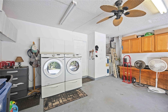 laundry room with ceiling fan, a textured ceiling, cabinets, and washing machine and dryer