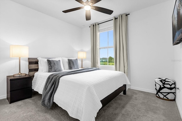 bedroom featuring ceiling fan and carpet