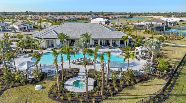 community pool featuring a residential view and a patio