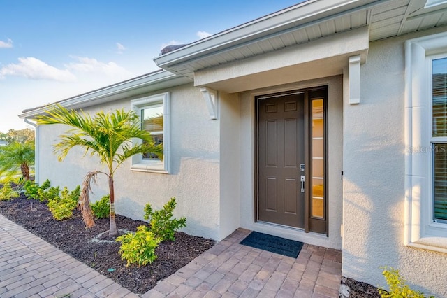 doorway to property with stucco siding