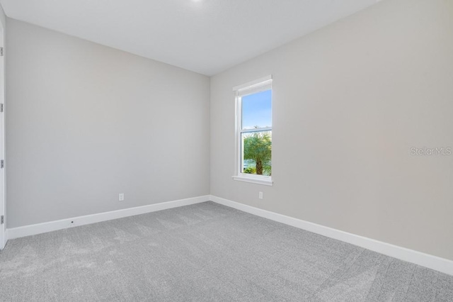 empty room with carpet and baseboards