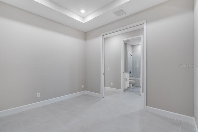 spare room with recessed lighting, visible vents, and baseboards