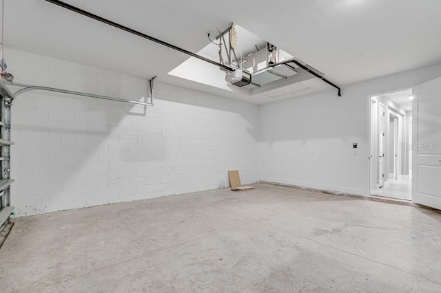 garage featuring a garage door opener and concrete block wall