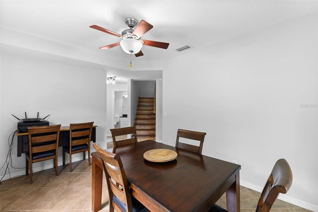 tiled dining room featuring ceiling fan