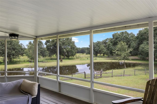 unfurnished sunroom featuring plenty of natural light and a water view