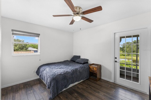 bedroom featuring multiple windows, ceiling fan, and dark hardwood / wood-style floors