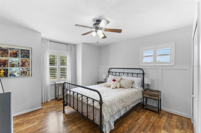 bedroom featuring ceiling fan and dark hardwood / wood-style flooring