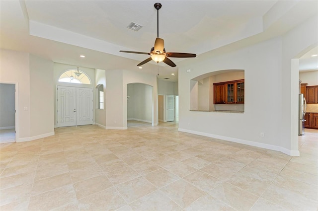 unfurnished living room with light tile patterned floors and ceiling fan