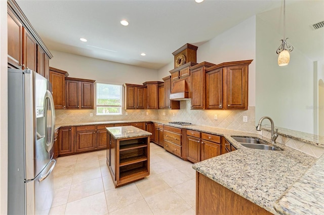 kitchen featuring kitchen peninsula, appliances with stainless steel finishes, custom range hood, sink, and hanging light fixtures