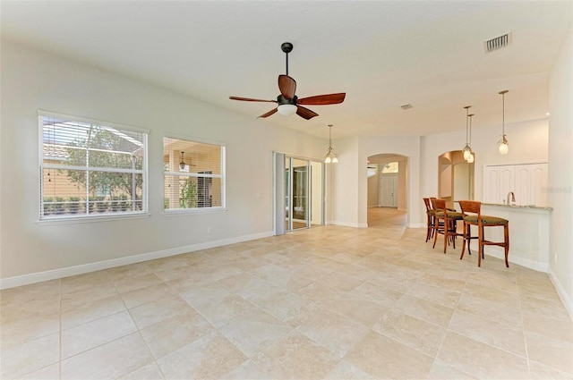 interior space with ceiling fan and light tile patterned floors