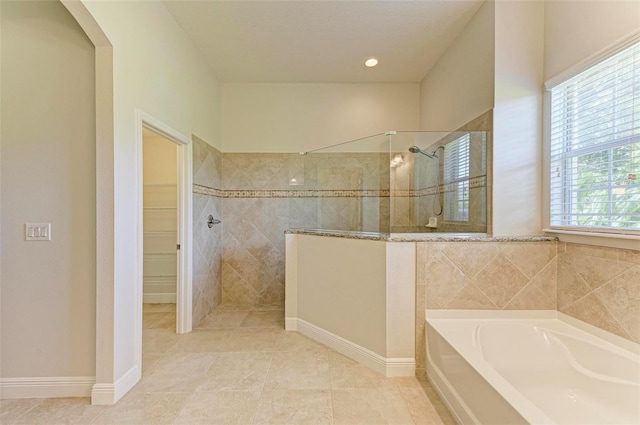 bathroom featuring tile patterned flooring and plus walk in shower