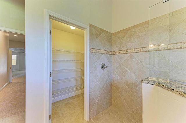 bathroom featuring tiled shower and tile patterned floors