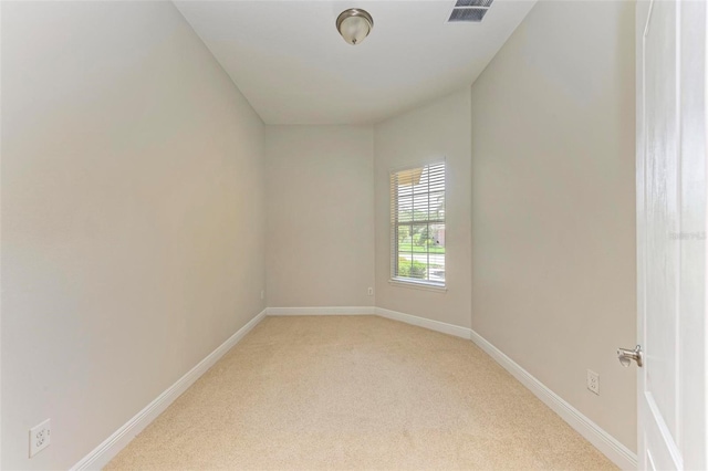 empty room featuring light carpet