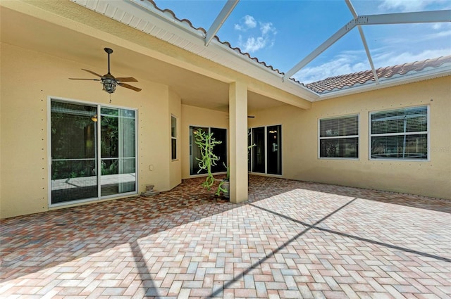 view of patio / terrace featuring glass enclosure and ceiling fan