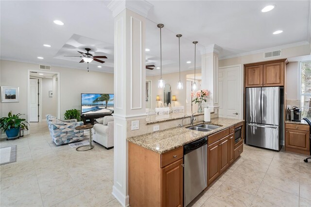 kitchen with hanging light fixtures, appliances with stainless steel finishes, ornate columns, sink, and ceiling fan