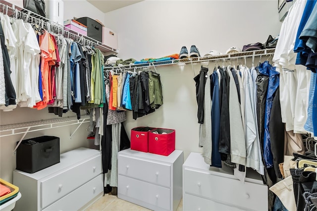 walk in closet with light tile patterned floors