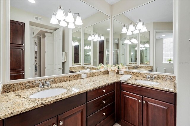 bathroom featuring vanity and a notable chandelier