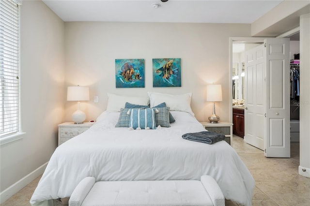 bedroom featuring baseboards and light tile patterned floors