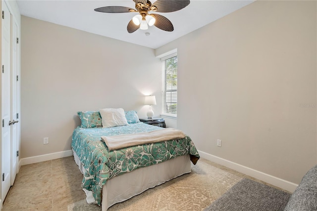 bedroom featuring a ceiling fan and baseboards